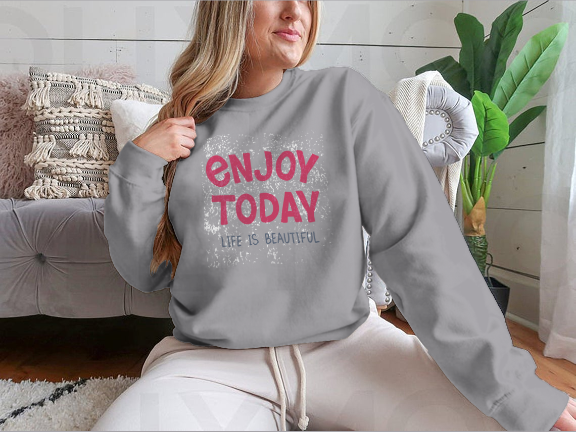 A comfortable t-shirt featuring hand-drawn typography that reads 'Enjoy Today', showcasing a stylish and inspirational design.