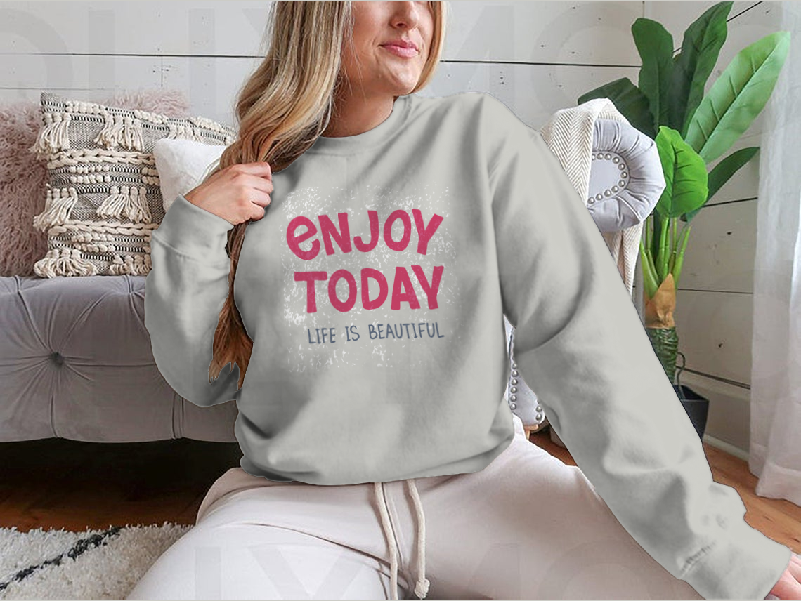 A comfortable t-shirt featuring hand-drawn typography that reads 'Enjoy Today', showcasing a stylish and inspirational design.