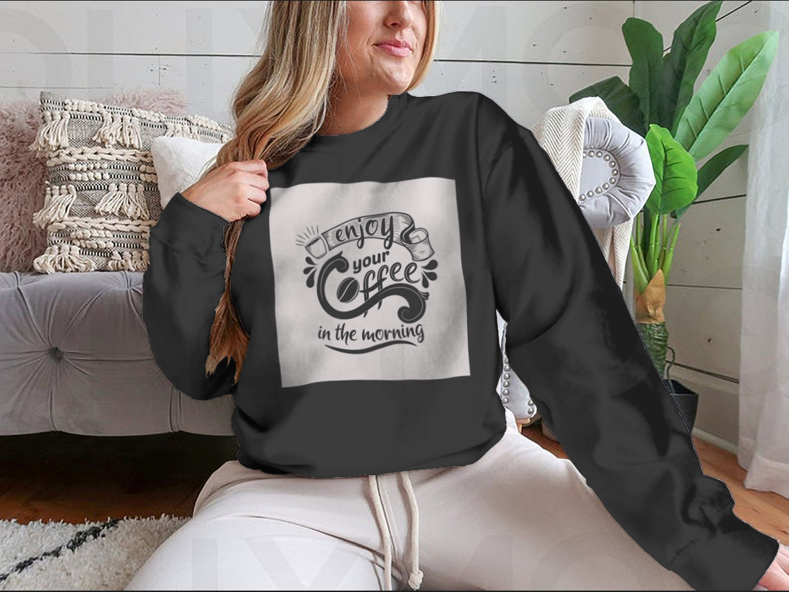 A comfortable premium motivational shirt featuring the quote 'Enjoy Your Coffee In The Morning', made from 100% cotton, displayed on a neutral background.