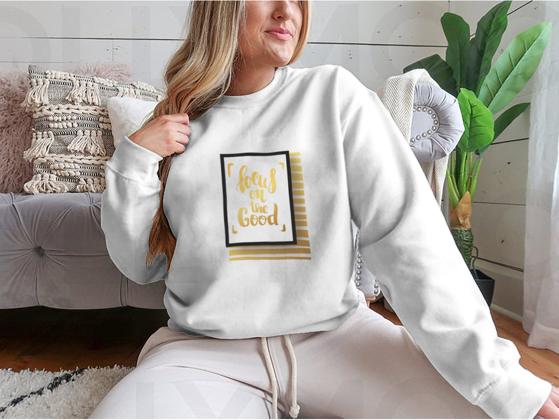 A cozy sweatshirt featuring the inspirational phrase 'Focus On The Good', made from a soft cotton-polyester blend.