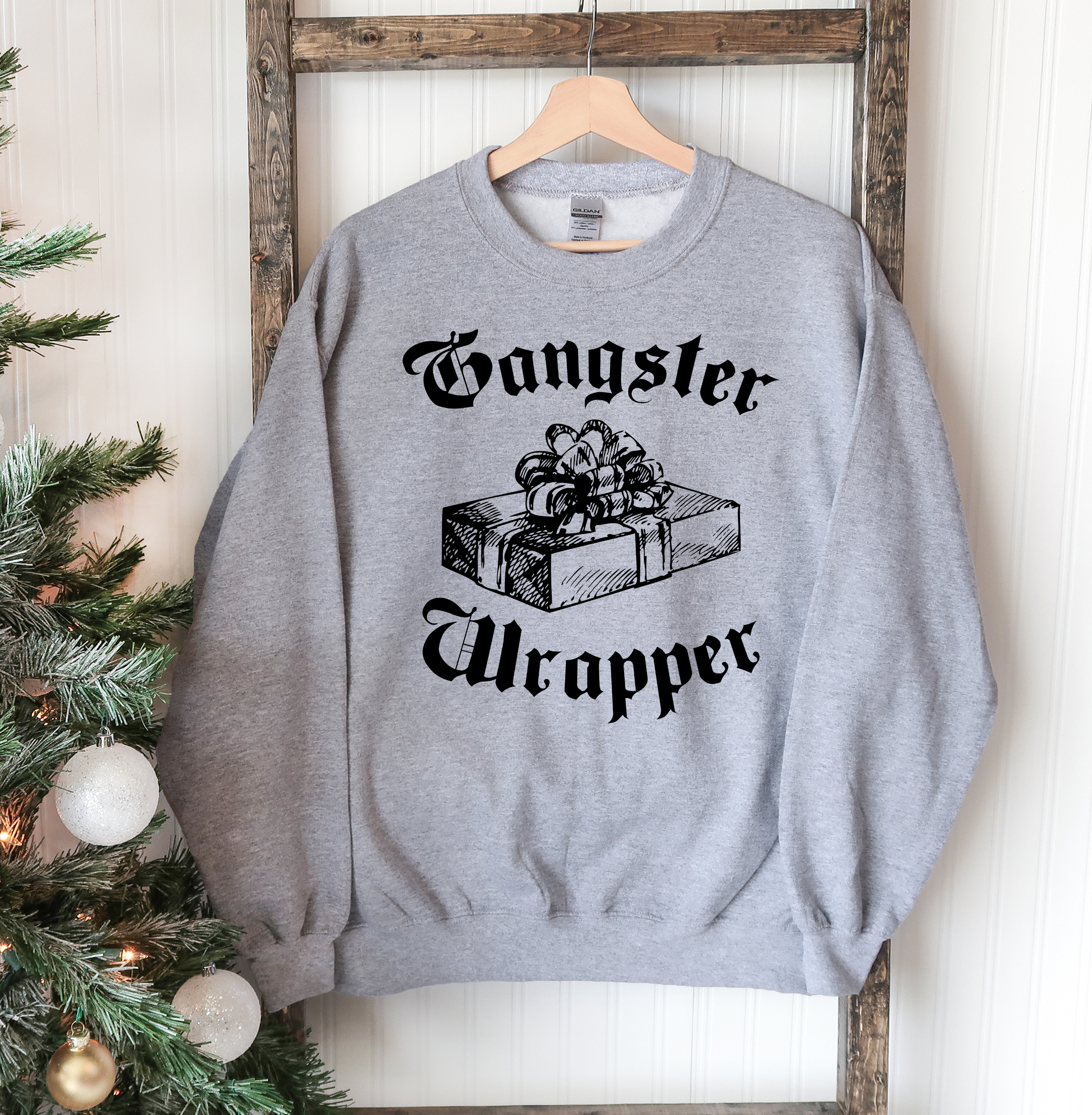 Gangsta Wrapper Christmas Sweatshirt featuring a crew neck design, soft fabric, and festive holiday theme, perfect for winter wear.