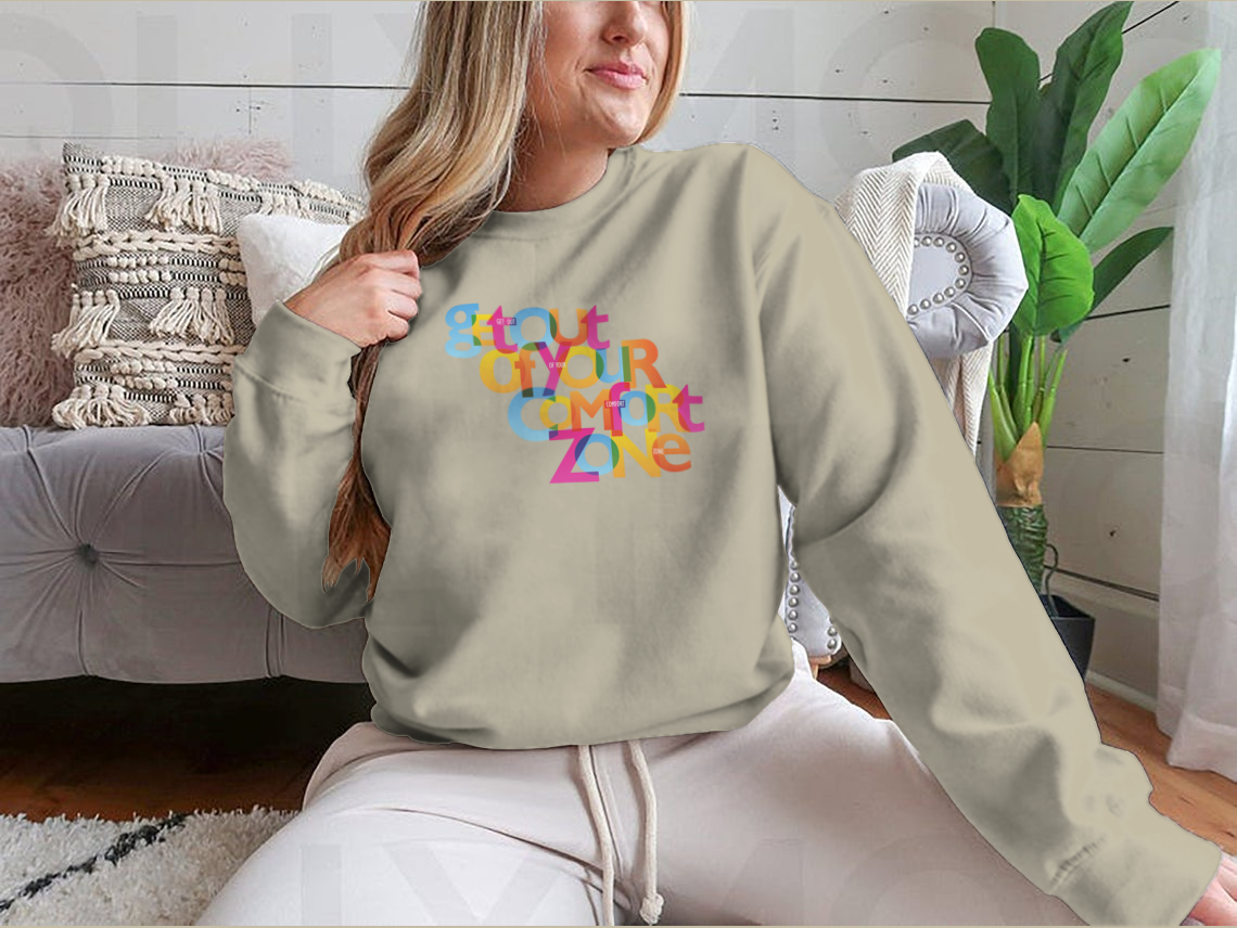 A stylish sweatshirt featuring the motivational phrase 'Get Out Of Your Comfort Zone', made from a soft cotton/polyester blend.