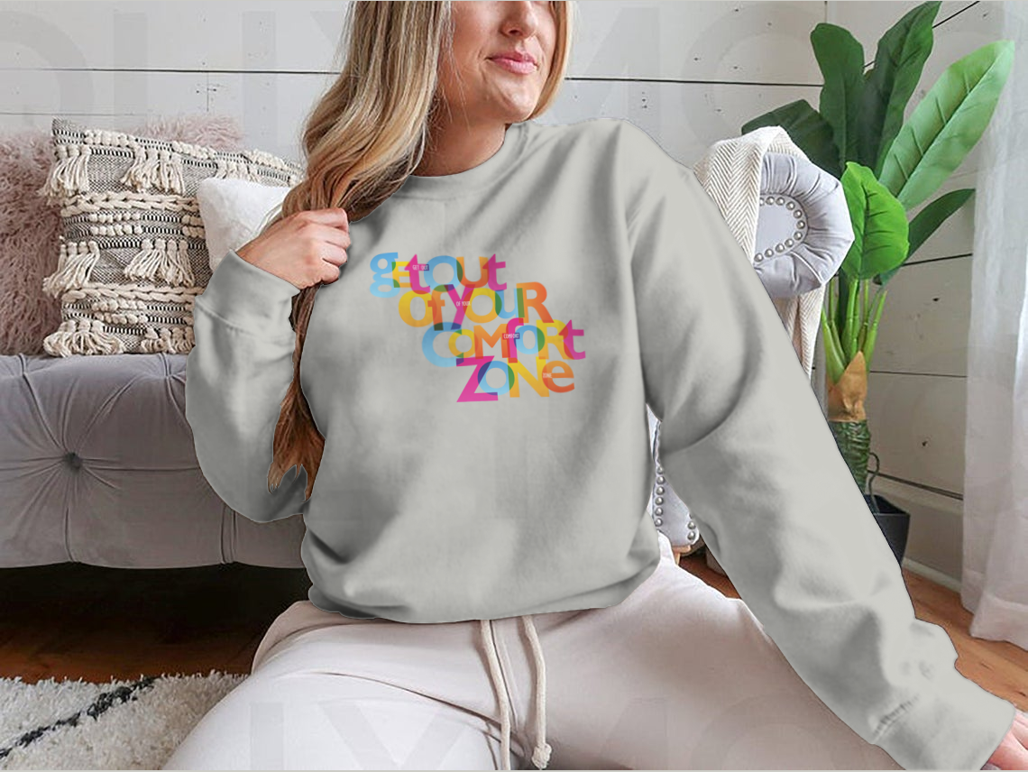 A stylish sweatshirt featuring the motivational phrase 'Get Out Of Your Comfort Zone', made from a soft cotton/polyester blend.