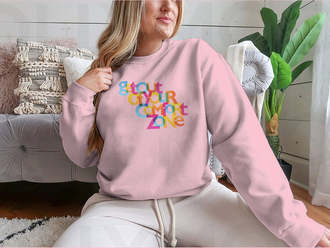 A stylish sweatshirt featuring the motivational phrase 'Get Out Of Your Comfort Zone', made from a soft cotton/polyester blend.