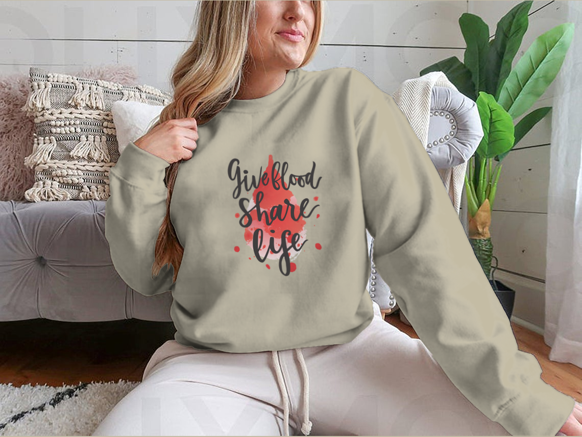 A stylish sweatshirt featuring a watercolor drop design with the phrase 'Give Blood Share Life', perfect for promoting blood donation awareness.