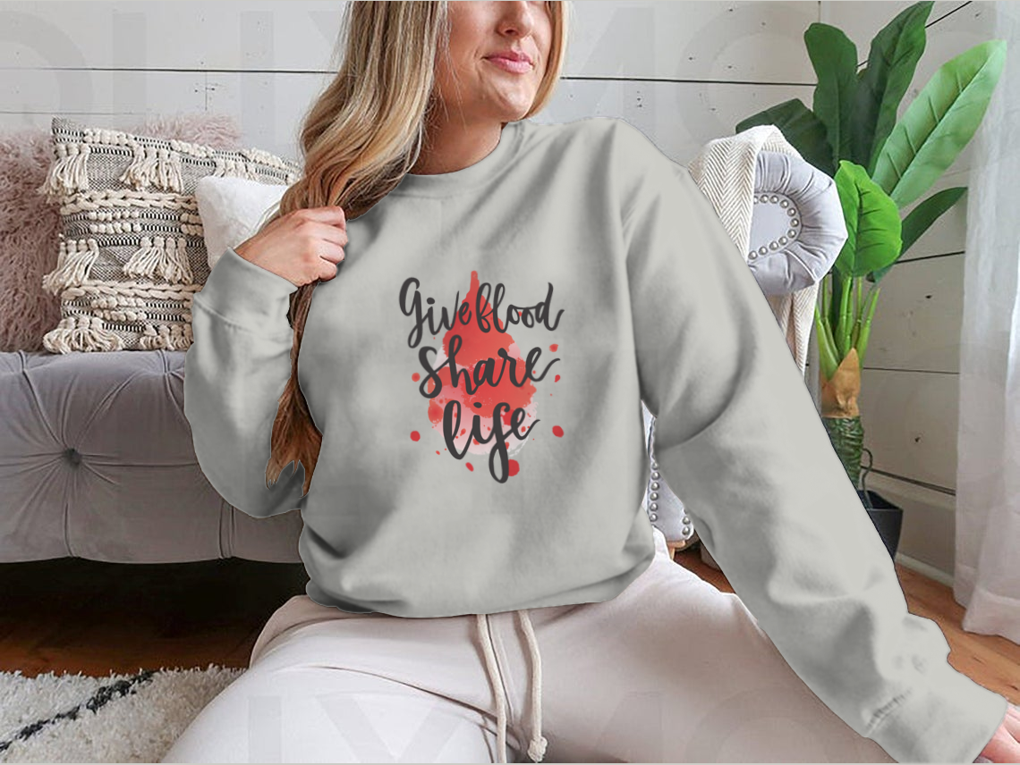 A stylish sweatshirt featuring a watercolor drop design with the phrase 'Give Blood Share Life', perfect for promoting blood donation awareness.