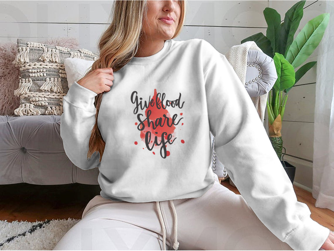 A stylish sweatshirt featuring a watercolor drop design with the phrase 'Give Blood Share Life', perfect for promoting blood donation awareness.