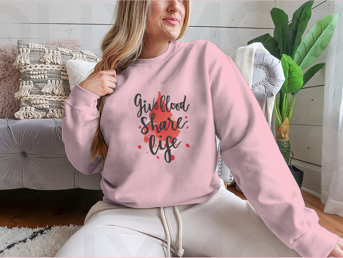 A stylish sweatshirt featuring a watercolor drop design with the phrase 'Give Blood Share Life', perfect for promoting blood donation awareness.