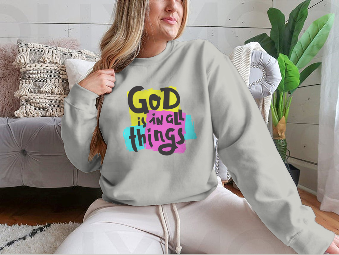 A cozy sweatshirt featuring the inspirational quote 'God Is In All Things' in a stylish design, perfect for everyday wear.