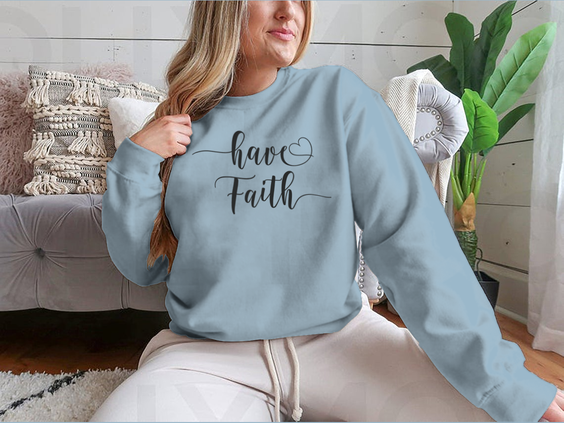 A cozy sweatshirt featuring the inspirational 'Have Faith' calligraphy design, made from soft cotton fabric.