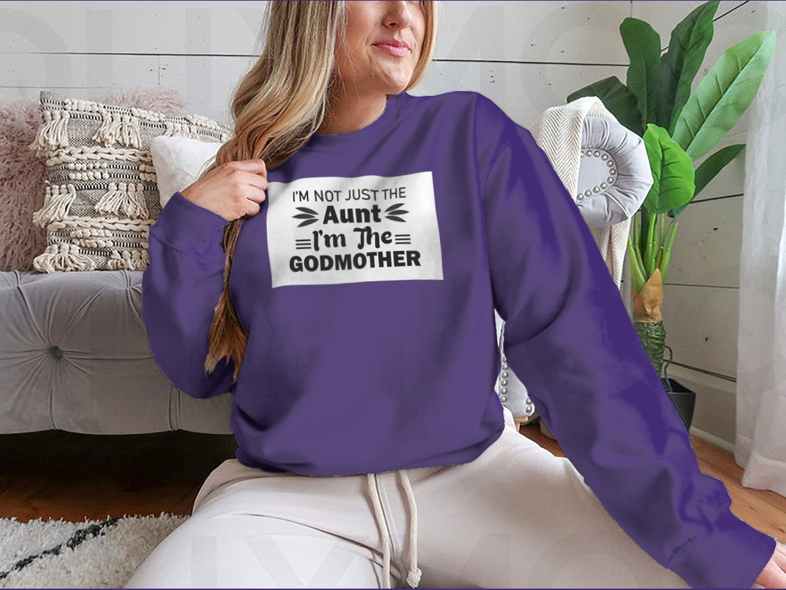 A stylish t-shirt featuring the phrase 'I'M Not Just The Aunt I'M The Godmother' in a fun design, showcasing its comfortable fit and quality fabric.