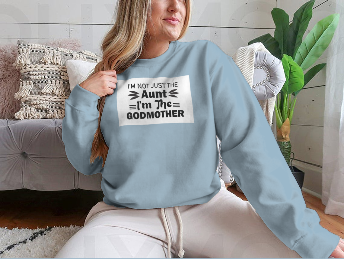 A stylish t-shirt featuring the phrase 'I'M Not Just The Aunt I'M The Godmother' in a fun design, showcasing its comfortable fit and quality fabric.