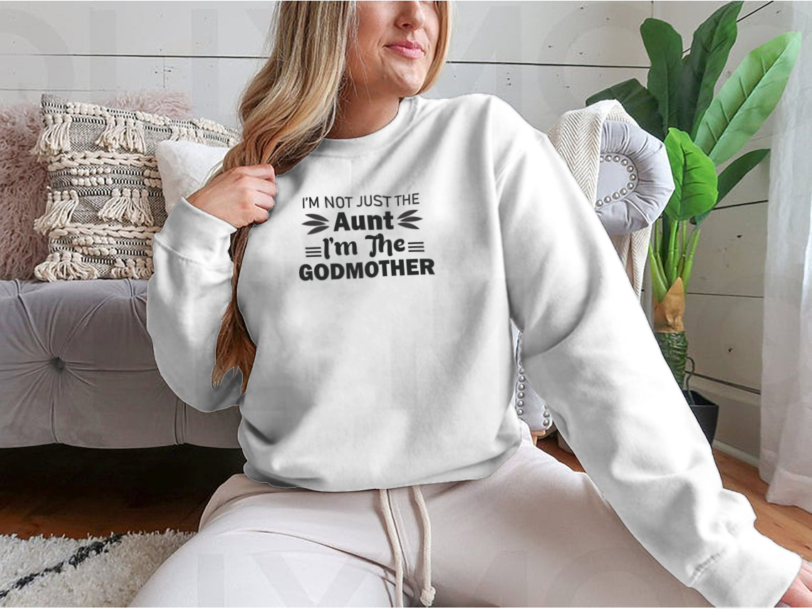 A stylish t-shirt featuring the phrase 'I'M Not Just The Aunt I'M The Godmother' in a fun design, showcasing its comfortable fit and quality fabric.