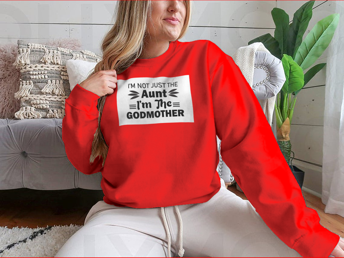 A stylish t-shirt featuring the phrase 'I'M Not Just The Aunt I'M The Godmother' in a fun design, showcasing its comfortable fit and quality fabric.