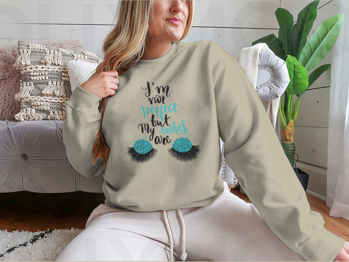 A stylish t-shirt featuring the phrase 'I'm Not Perfect, But My Lashes Are' in a motivational design, showcasing a classic fit and soft fabric.