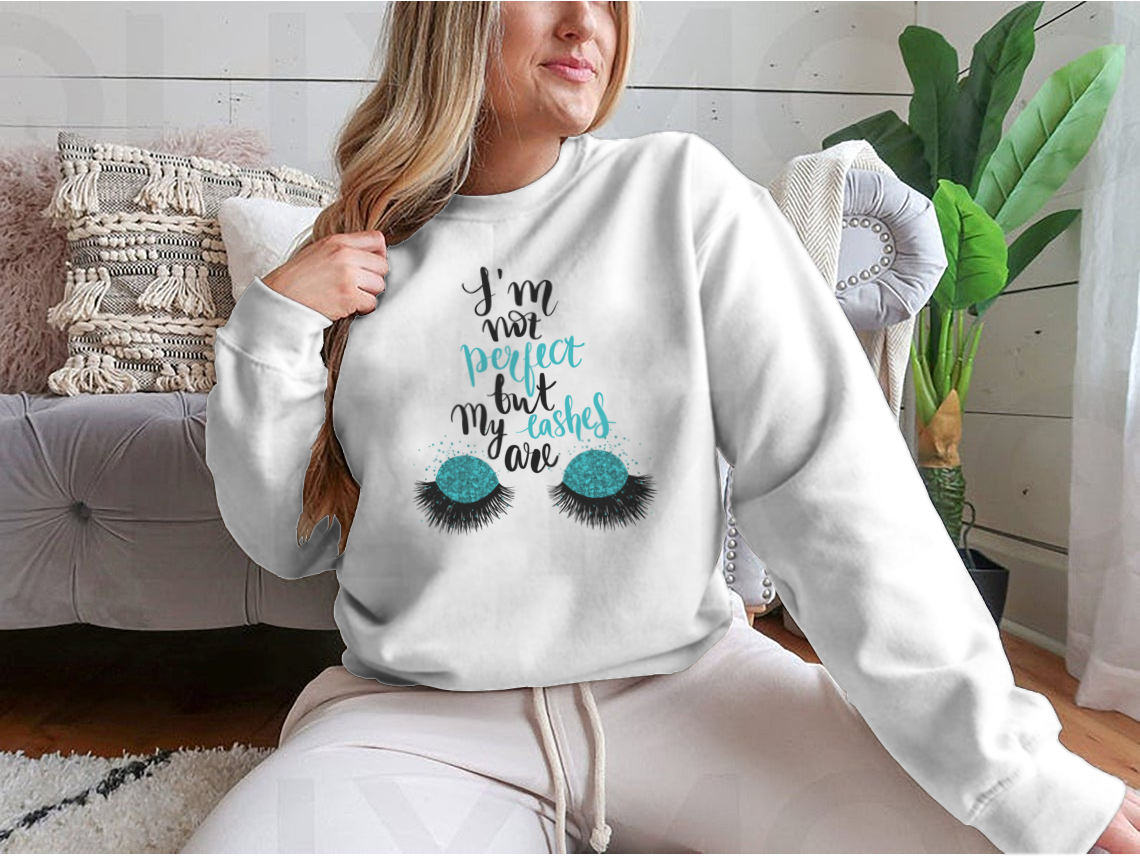 A stylish t-shirt featuring the phrase 'I'm Not Perfect, But My Lashes Are' in a motivational design, showcasing a classic fit and soft fabric.