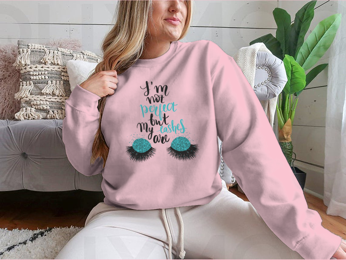 A stylish t-shirt featuring the phrase 'I'm Not Perfect, But My Lashes Are' in a motivational design, showcasing a classic fit and soft fabric.