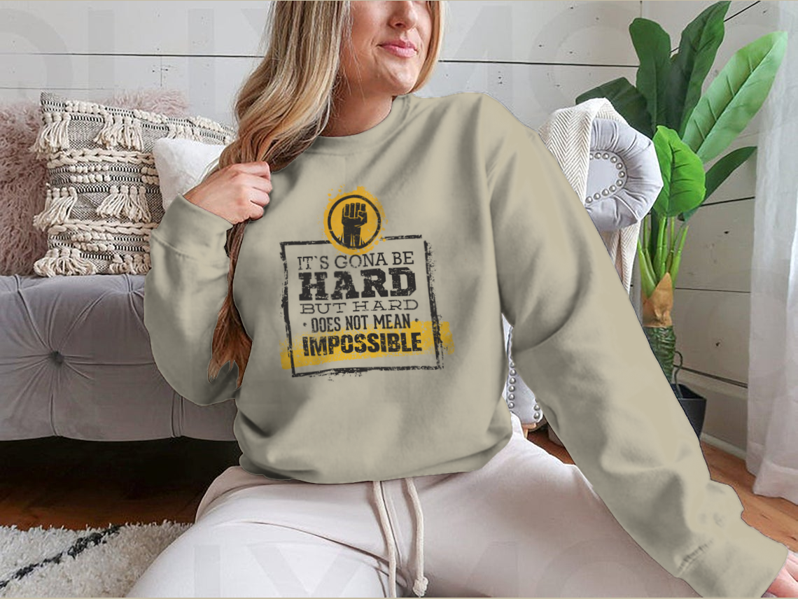 Motivational t-shirt featuring the phrase 'Hard Does Not Mean Impossible' in a stylish design, made from a comfortable cotton/polyester blend.