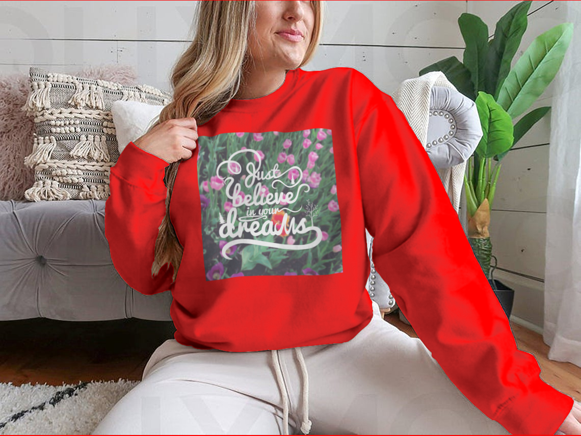 A stylish apparel featuring a blurred background with vibrant tulips and the motivational phrase 'Just Believe In Your Dreams'.