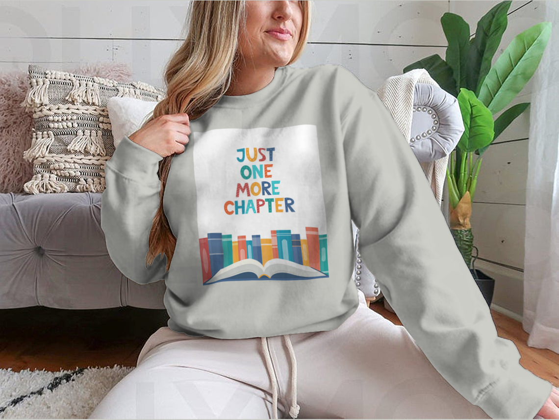 A cozy sweatshirt featuring the phrase 'Just One More Chapter', perfect for book lovers, made from soft cotton fabric.