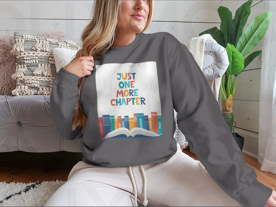 A cozy sweatshirt featuring the phrase 'Just One More Chapter', perfect for book lovers, made from soft cotton fabric.