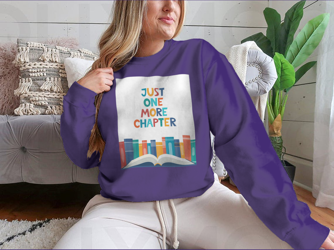 A cozy sweatshirt featuring the phrase 'Just One More Chapter', perfect for book lovers, made from soft cotton fabric.