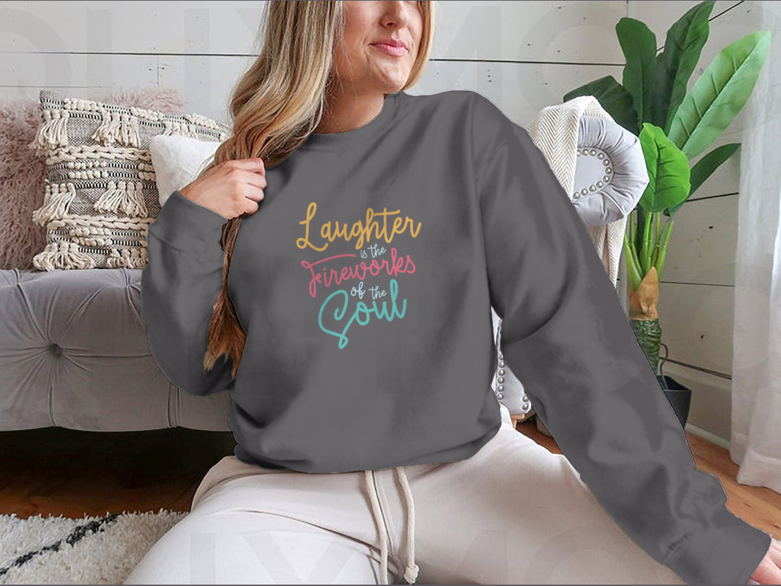 A motivational apparel piece featuring the phrase 'Laughter Is The Fireworks Of The Soul' on a comfortable cotton blend fabric.