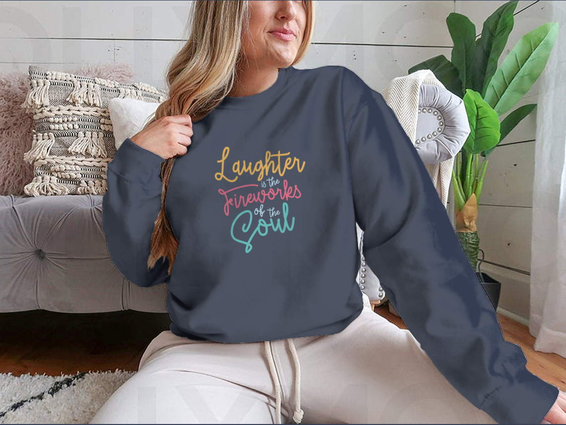 A motivational apparel piece featuring the phrase 'Laughter Is The Fireworks Of The Soul' on a comfortable cotton blend fabric.