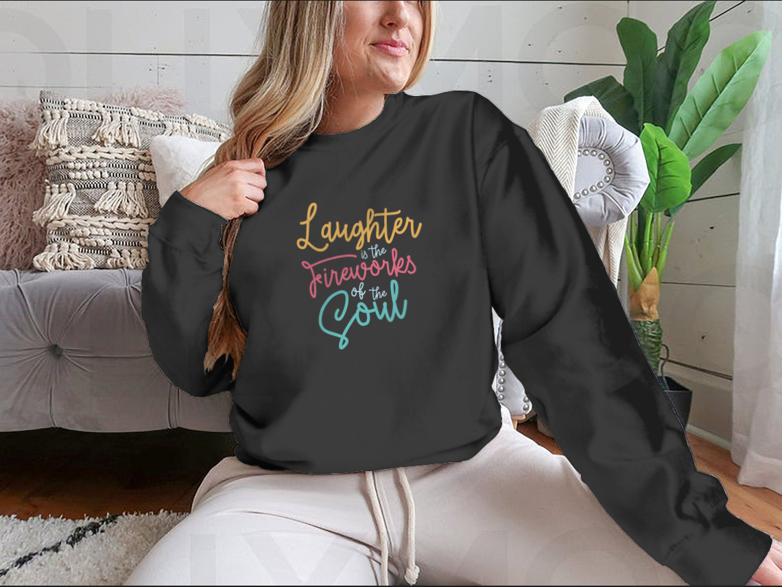 A motivational apparel piece featuring the phrase 'Laughter Is The Fireworks Of The Soul' on a comfortable cotton blend fabric.