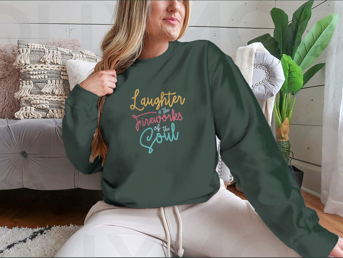 A motivational apparel piece featuring the phrase 'Laughter Is The Fireworks Of The Soul' on a comfortable cotton blend fabric.