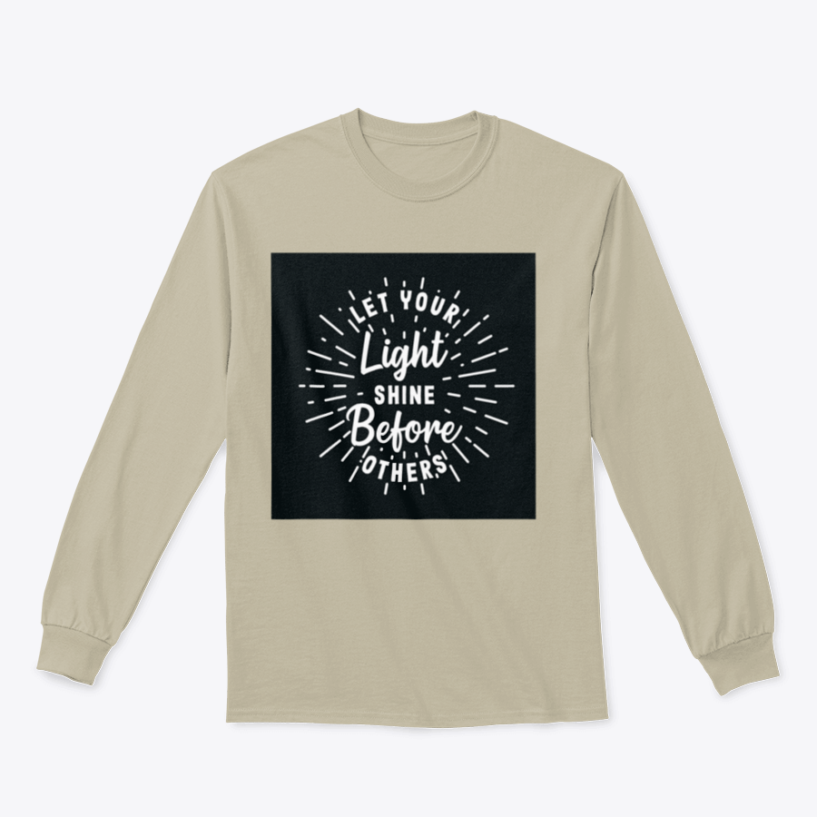 A stylish hand lettering typography shirt with the phrase 'Let Your Light Shine Before Others' displayed prominently, made from soft cotton fabric.