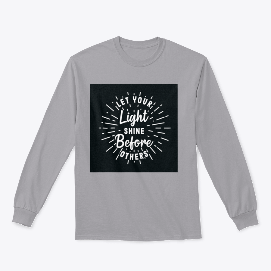 A stylish hand lettering typography shirt with the phrase 'Let Your Light Shine Before Others' displayed prominently, made from soft cotton fabric.