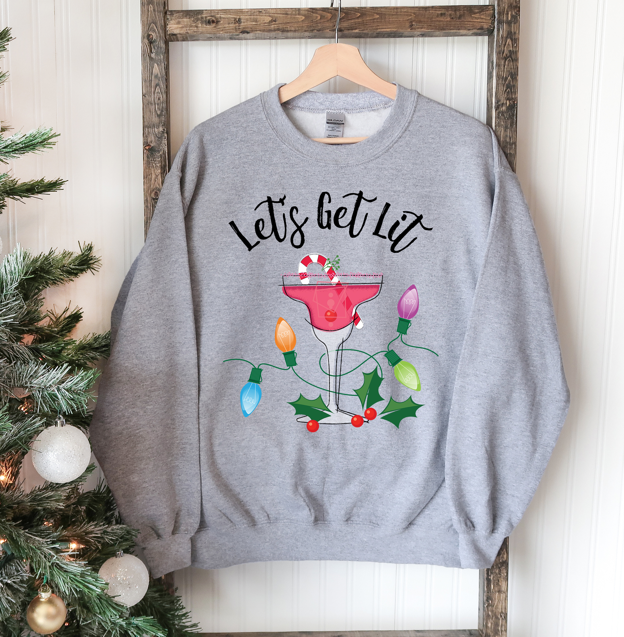 A cozy unisex sweatshirt featuring a festive 'Let's Get Lit' design, perfect for Christmas celebrations.