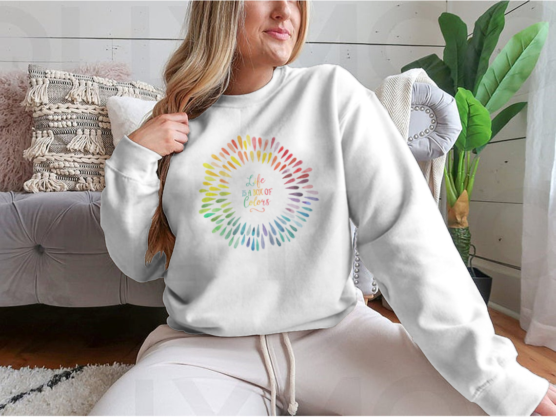 A cozy sweatshirt featuring the motivational quote 'Life Is A Box Of Colors' in vibrant colors, perfect for casual wear.