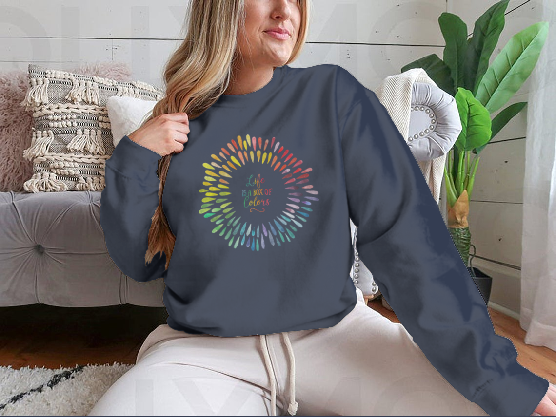 A cozy sweatshirt featuring the motivational quote 'Life Is A Box Of Colors' in vibrant colors, perfect for casual wear.