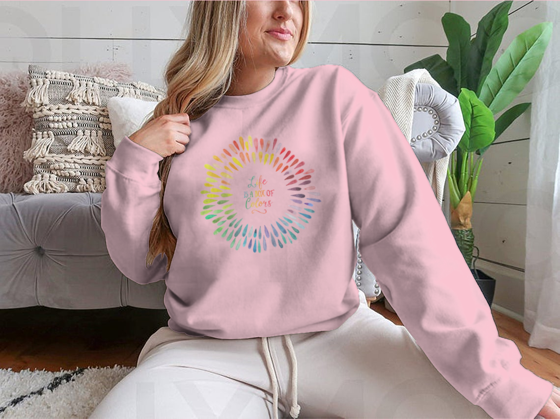 A cozy sweatshirt featuring the motivational quote 'Life Is A Box Of Colors' in vibrant colors, perfect for casual wear.