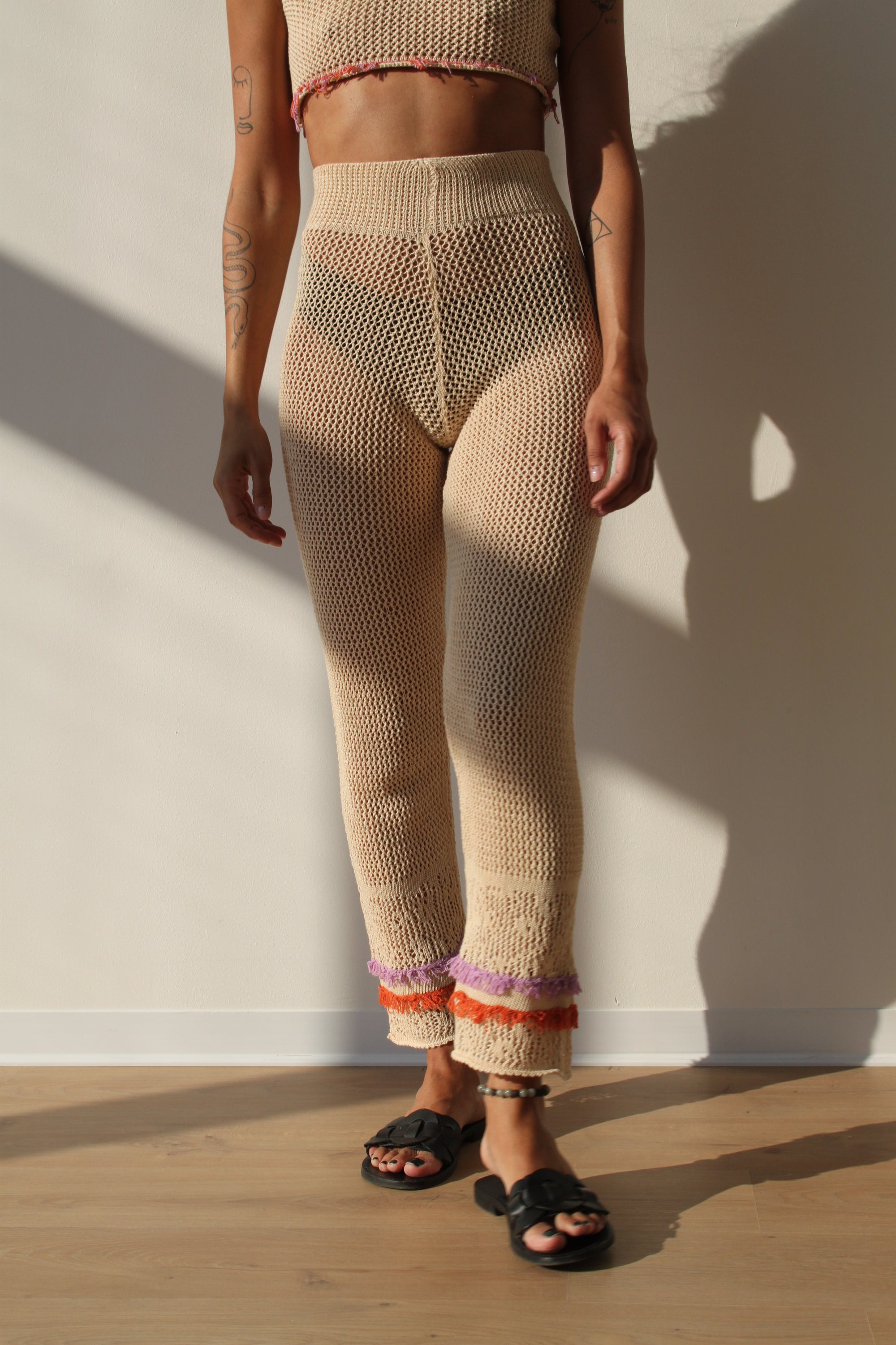 Linda Pants in Champagne color featuring colorful fringes at the hem, perfect for summer outings.