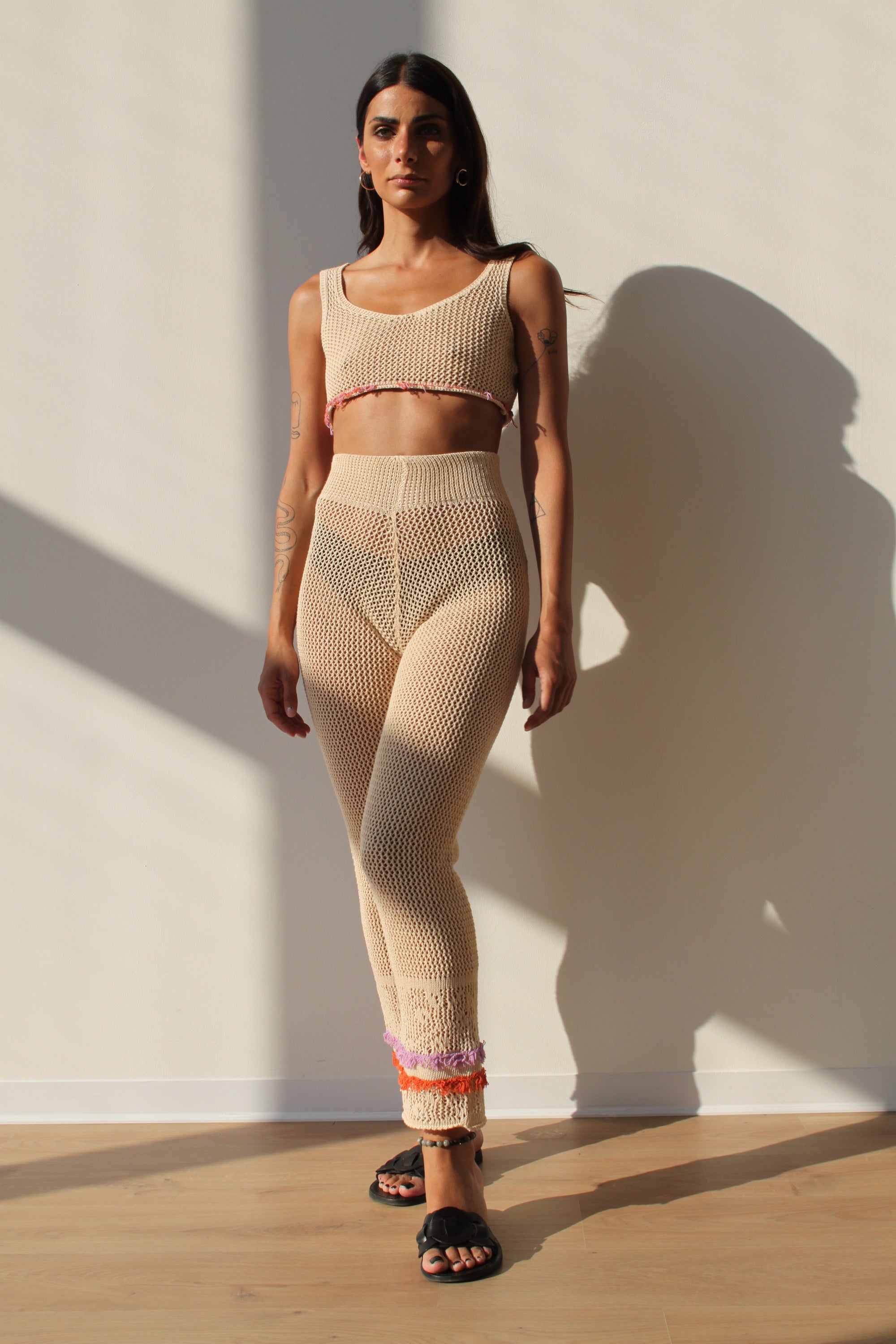 Linda Pants in Champagne color featuring colorful fringes at the hem, perfect for summer outings.