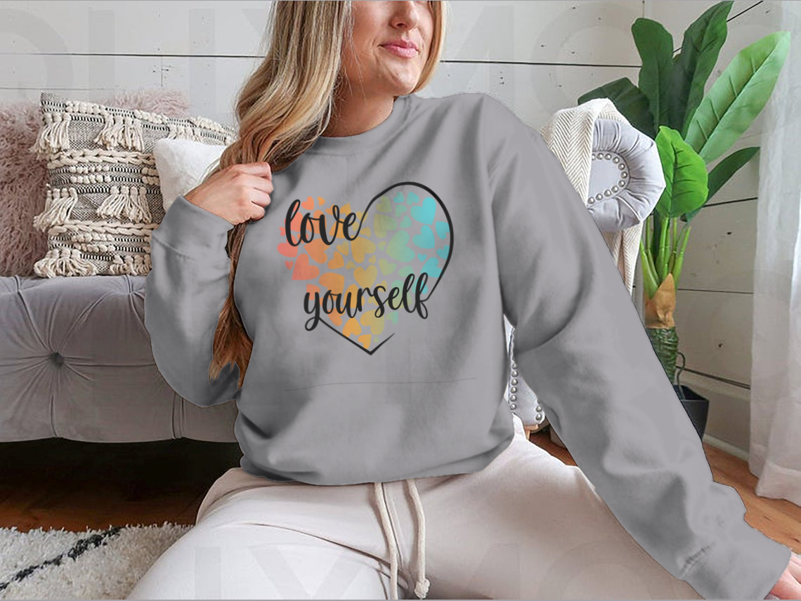 A cozy sweatshirt featuring a unique Love Yourself design with hearts and lettering, perfect for casual wear.