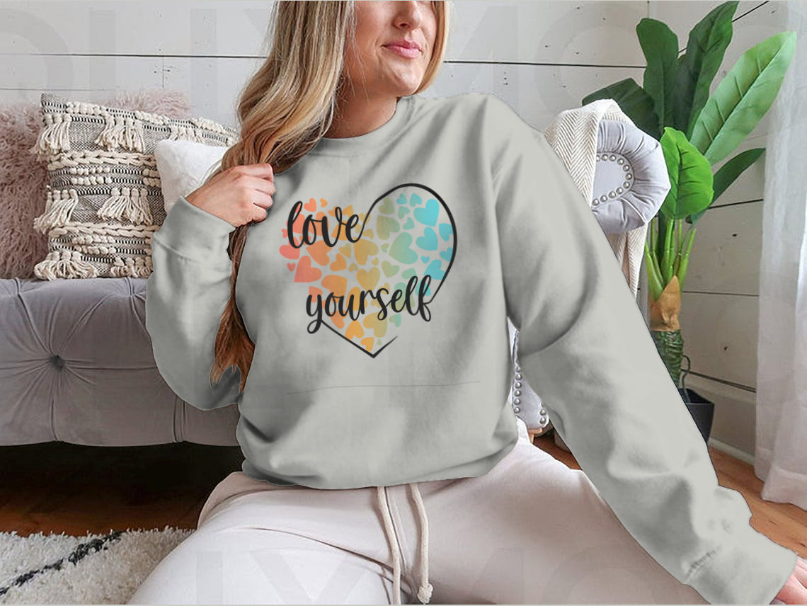 A cozy sweatshirt featuring a unique Love Yourself design with hearts and lettering, perfect for casual wear.