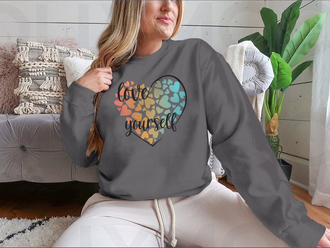 A cozy sweatshirt featuring a unique Love Yourself design with hearts and lettering, perfect for casual wear.