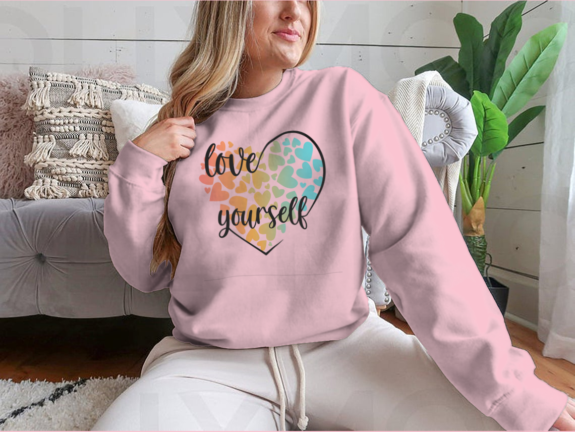 A cozy sweatshirt featuring a unique Love Yourself design with hearts and lettering, perfect for casual wear.