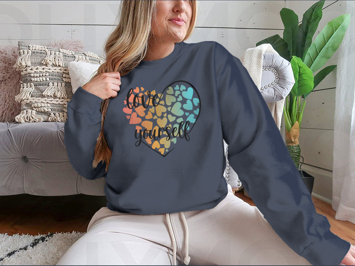 A cozy sweatshirt featuring a unique Love Yourself design with hearts and lettering, perfect for casual wear.