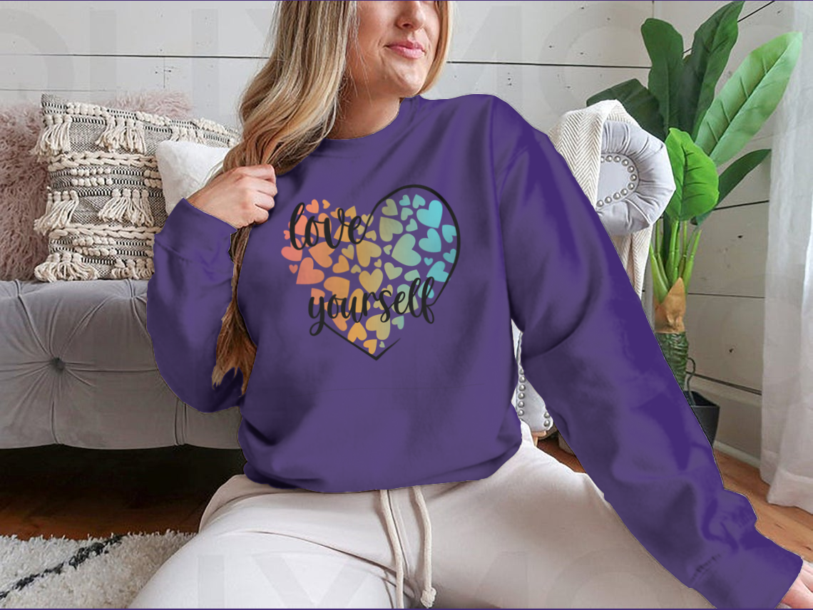 A cozy sweatshirt featuring a unique Love Yourself design with hearts and lettering, perfect for casual wear.