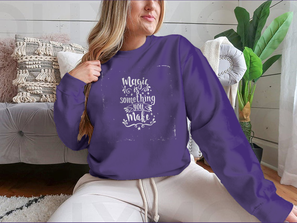 A cozy sweatshirt featuring the phrase 'Magic Is Something You Make', showcasing a classic fit and soft fabric blend.