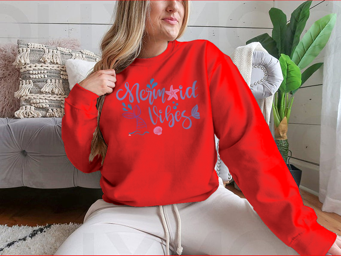 A cozy sweatshirt featuring a whimsical mermaid design, made from 100% cotton, perfect for casual wear.