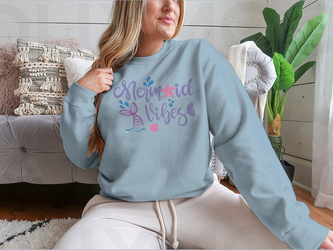 A cozy sweatshirt featuring a whimsical mermaid design, made from 100% cotton, perfect for casual wear.