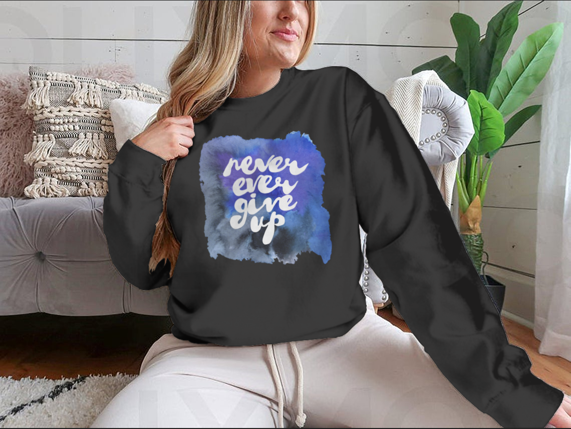 A motivational shirt design featuring the phrase 'Never Ever Give Up', made from soft cotton fabric, showcasing a classic fit and durable construction.