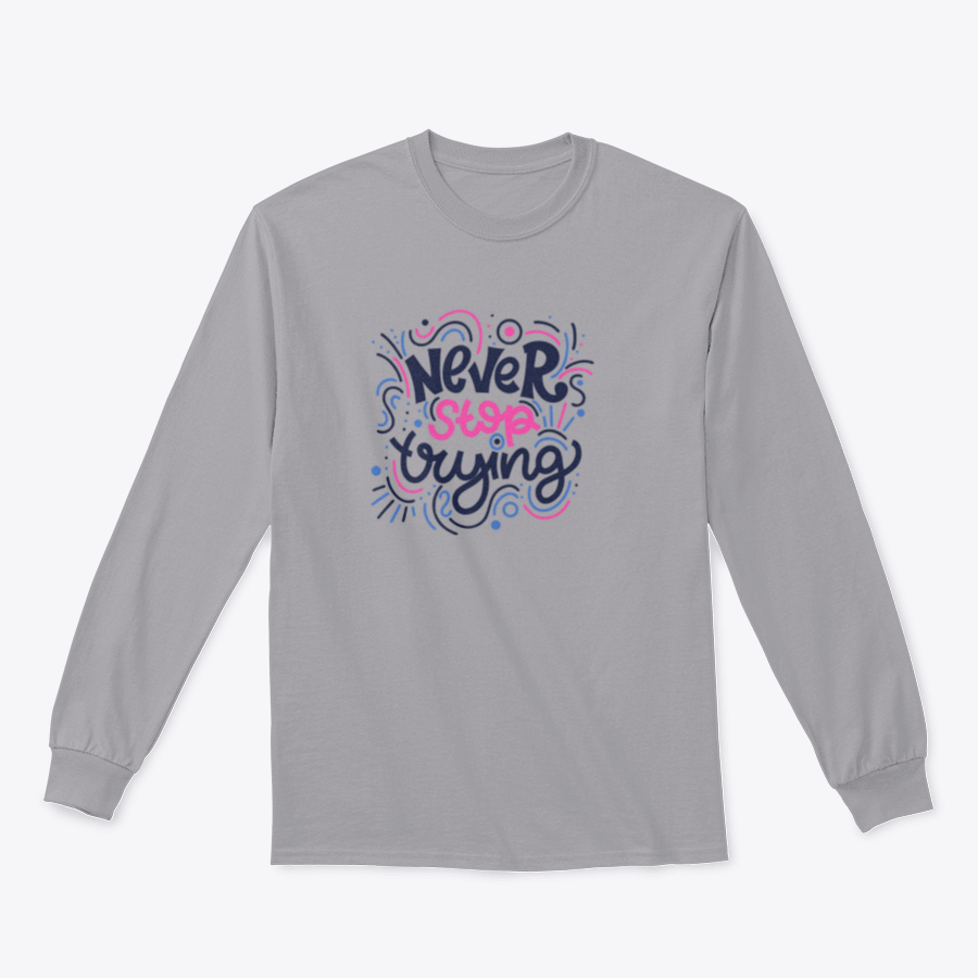 A vibrant t-shirt featuring the motivational phrase 'Never Stop Trying' in bright colored letters, showcasing a modern hand-drawn design.