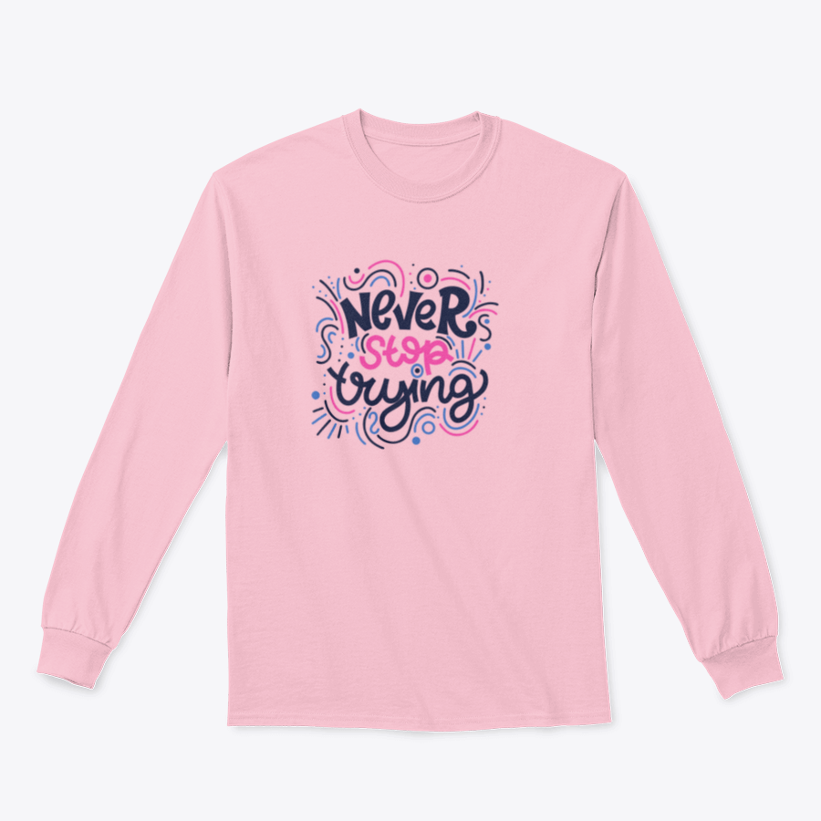 A vibrant t-shirt featuring the motivational phrase 'Never Stop Trying' in bright colored letters, showcasing a modern hand-drawn design.